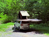 Silver 4WD Mitsubishi Delica van with rooftop tent & awning, perfect rv rental for camping and overlanding adventures.
