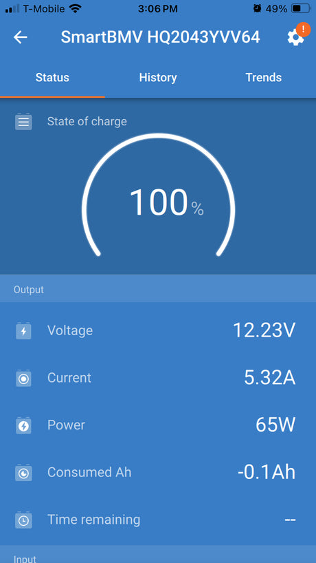 RV rental power display: 100% battery, 12.23V, 65W output. Battery monitor app for camper power management.