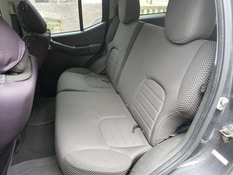 Clean gray fabric back seats of a vehicle, showing good condition. Perfect for road trips alongside your RV rental.