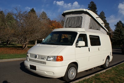  perfect for an RV rental adventure or road trip travel.|Cozy RV rental interior with a laptop on a bed
