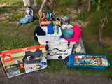 RV rental ready! Camp stove, tent, cooler, and cooking essentials laid out for outdoor adventures.