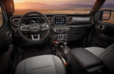 Jeep vehicle interior: detailed dashboard, steering wheel, and comfortable seats, ideal for outdoor trips beyond an RV rental.