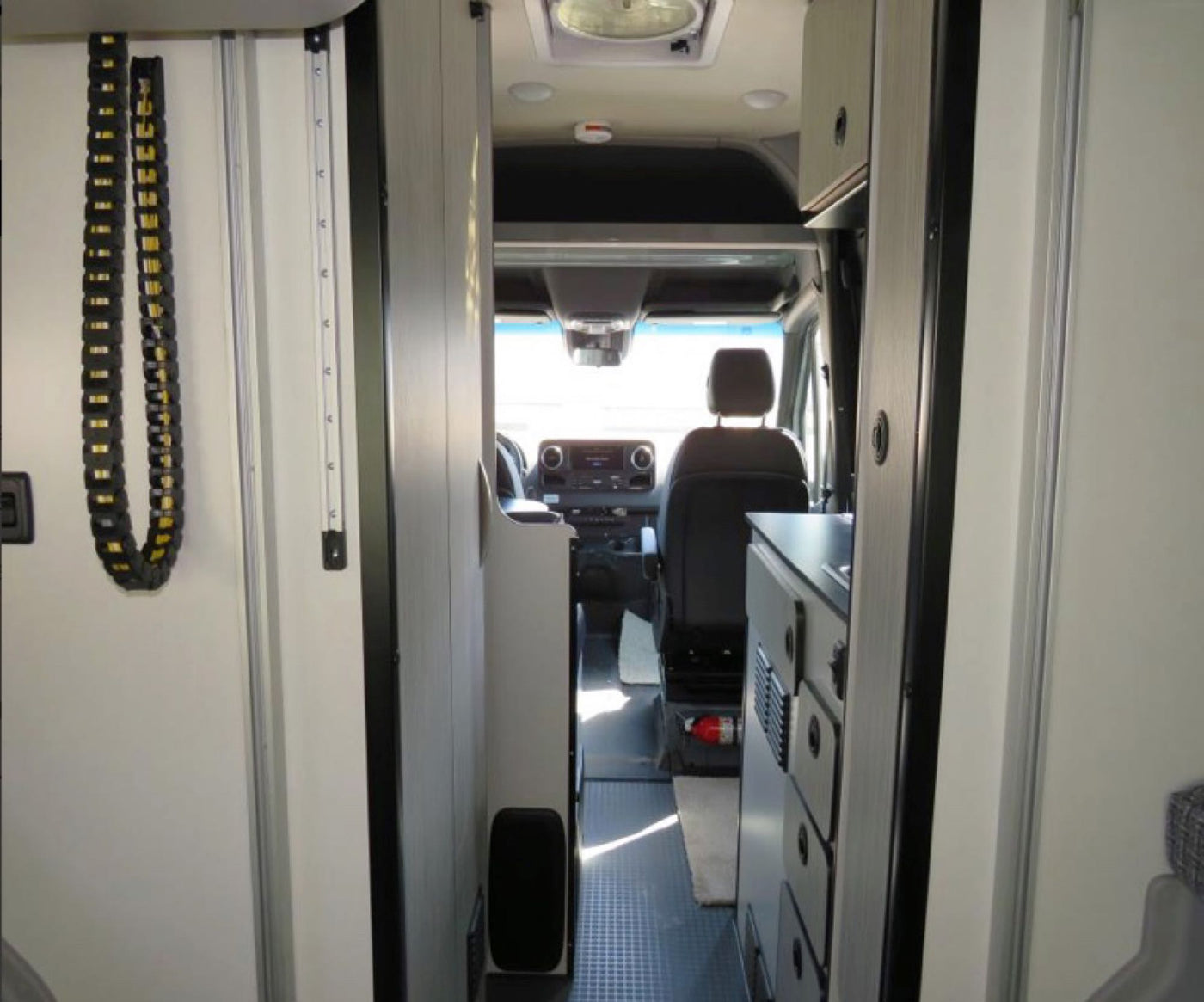  and side steps.|Inside an rv rental camper van: rear view showcasing open doors — photo 6