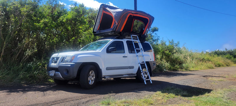 White Nissan Xterra SUV with a deployed rooftop tent and ladder. This RV rental is ready for outdoor adventure. — photo 1