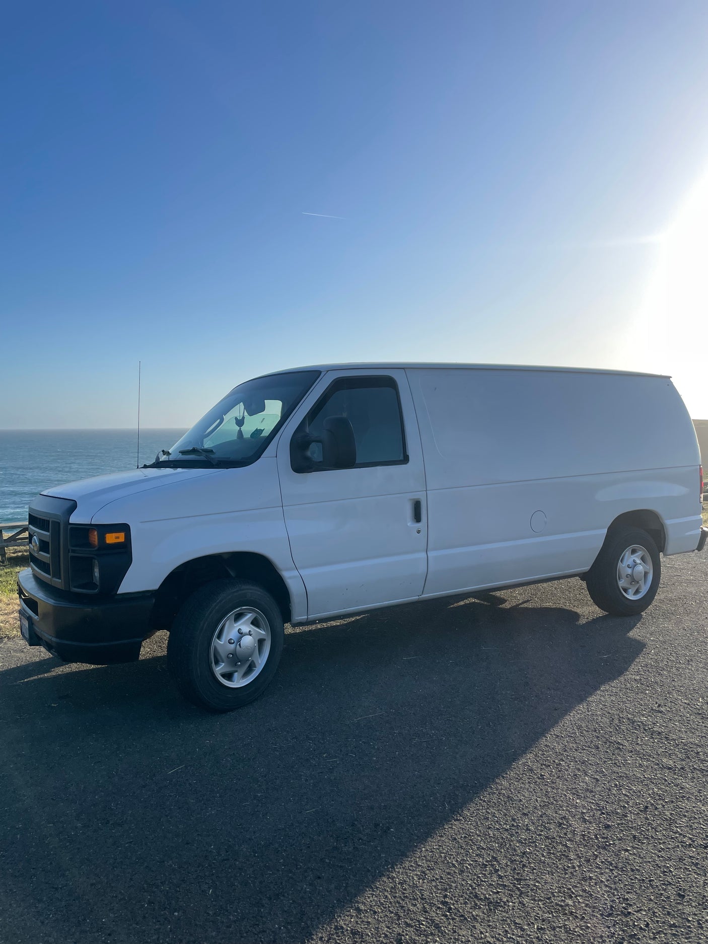 Explore the coast in this white van, an ideal rv rental for scenic road trips by the ocean.