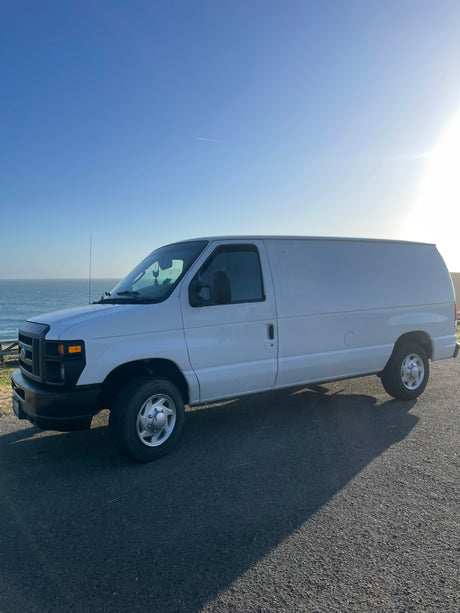 Explore the coast in this white van, an ideal rv rental for scenic road trips by the ocean.