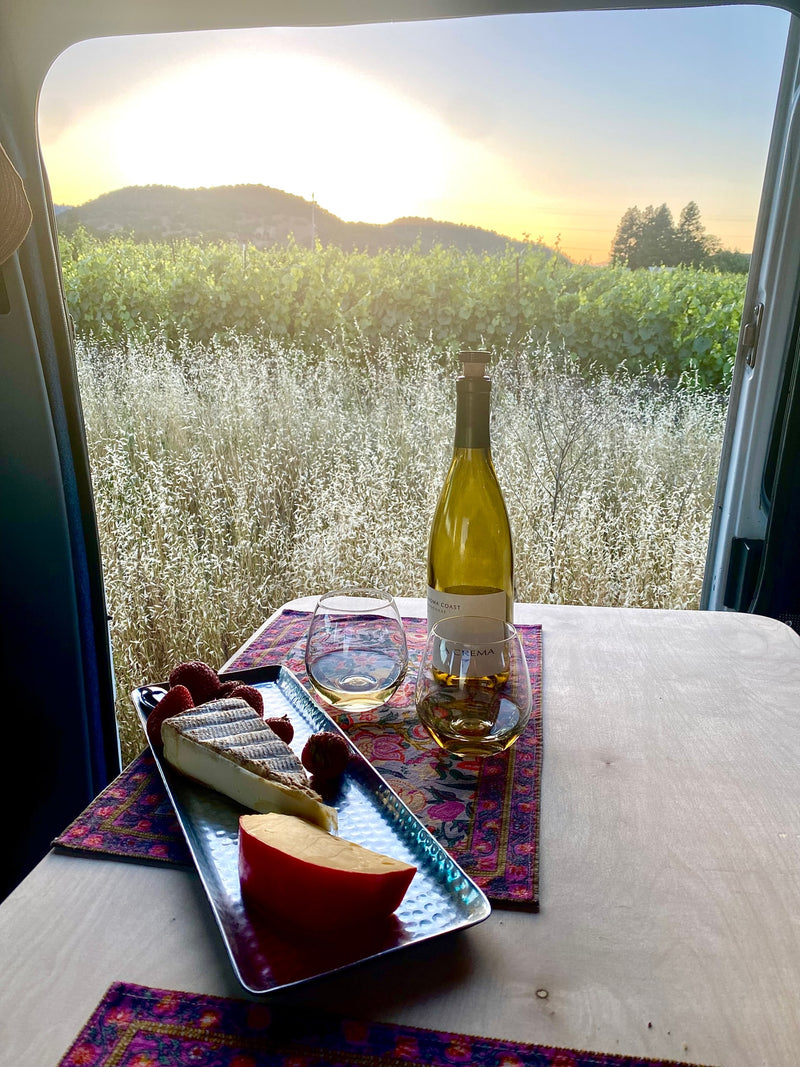 with snacks and a meal ready at his mobile workstation.|A cozy RV rental interior with a table set for a meal — photo 32