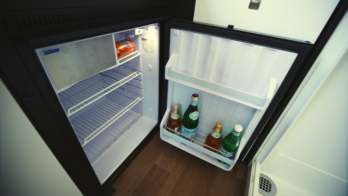 This RV rental mini-fridge with drinks like San Pellegrino and Kist soda, ready for your compact travel adventures. — photo 11