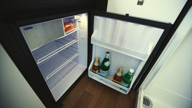 This RV rental mini-fridge with drinks like San Pellegrino and Kist soda, ready for your compact travel adventures. — photo 11
