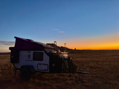 Rugged Mission Overland off-road RV rental, perfect for desert adventures at sunset.