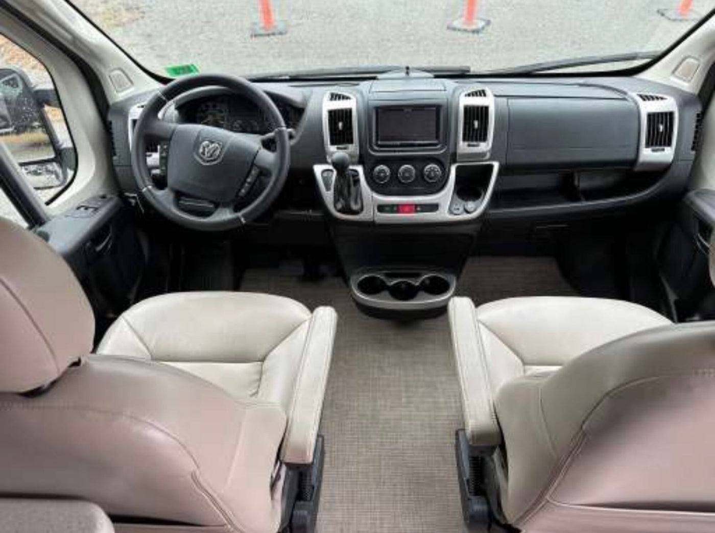  and compact fridge. Perfect for travel convenience.|This rv rental offers a comfortable interior with twin benches — photo 7