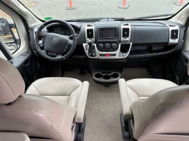  and compact fridge. Perfect for travel convenience.|This rv rental offers a comfortable interior with twin benches — photo 7