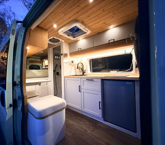 RV rental interior: A modern camper van with a compact kitchen