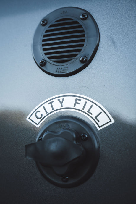 RV rental: "CITY FILL" water inlet with knob and utility vent, for connecting to city water supply.