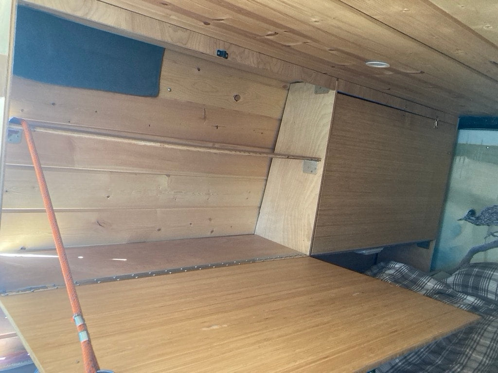  enhancing its unique charm.|See this RV rental's custom wood interior with a handy fold-down table — photo 17