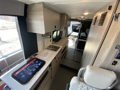  and dining.|RV rental interior: cozy camper van with wood-slat bed — photo 5