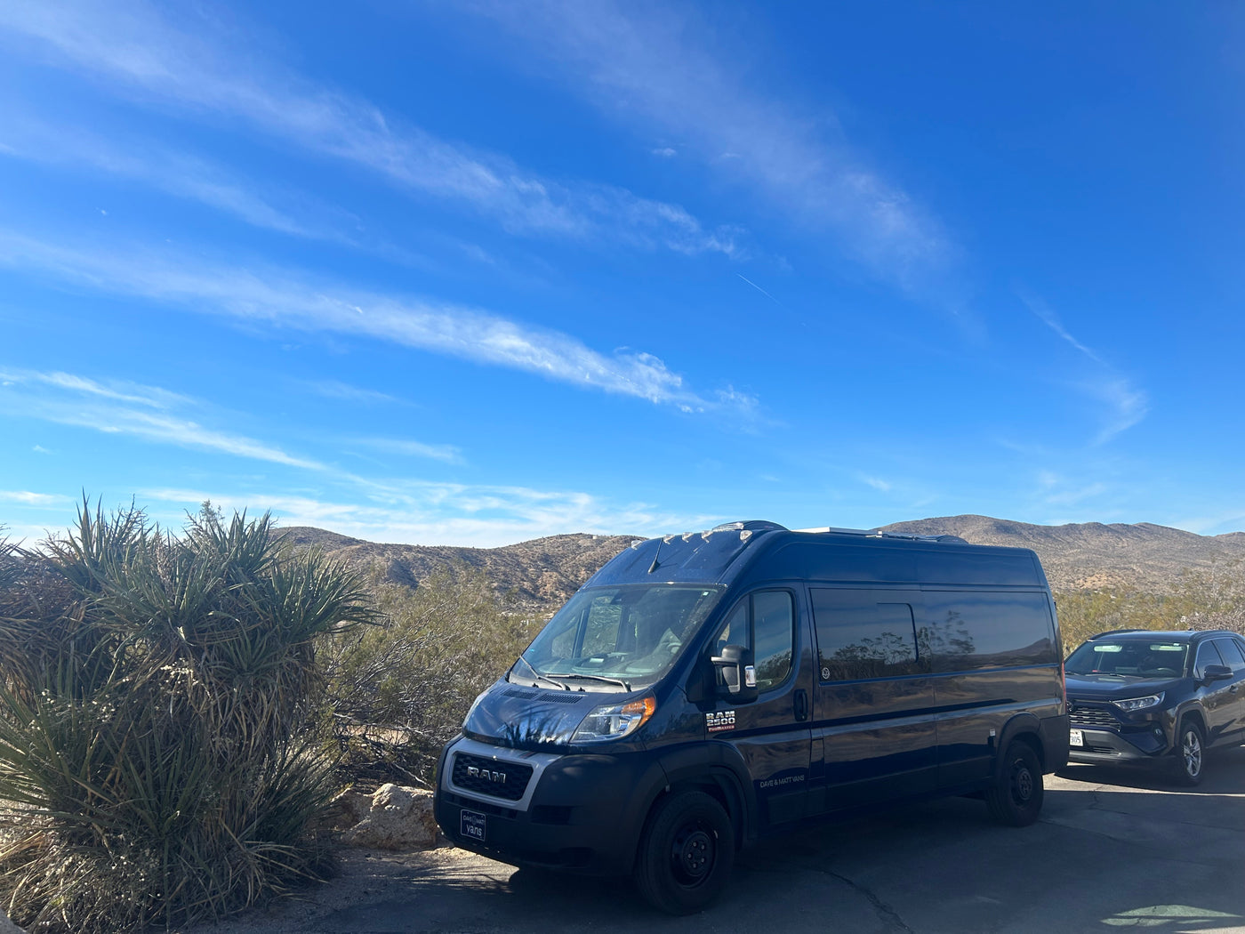 Dark blue RAM ProMaster camper van (RV rental) & SUV parked in a scenic desert mountain landscape. — photo 7