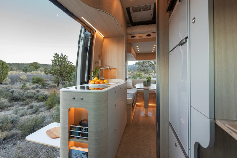 Modern RV rental living space: a stylish van conversion with kitchen — photo 1