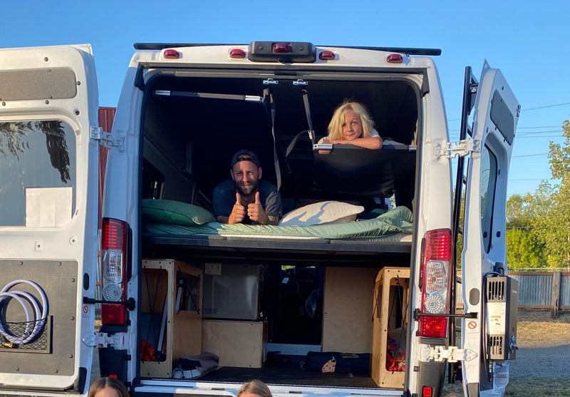 Two people enjoy their RV rental. A man gives thumbs up from the bottom bunk, and a child smiles from the top bunk. — photo 6