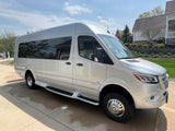 A silver Mercedes-Benz Sprinter van, ideal for rv rental adventures. This luxury conversion van is parked on a sunny driveway.