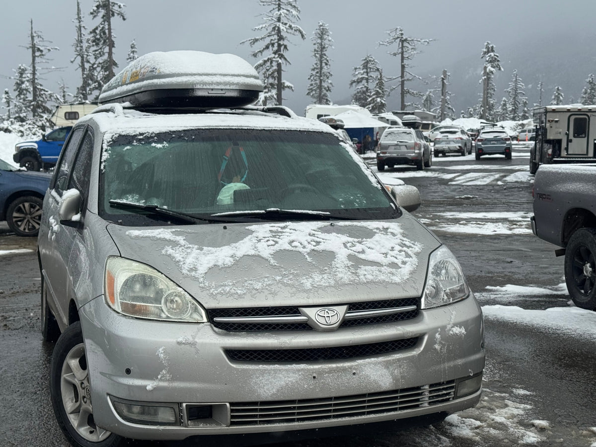 Silver minivan in a snowy lot