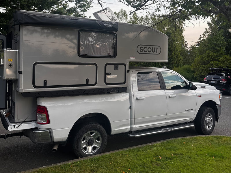 White Ram pickup with a light grey Scout truck camper — photo 1
