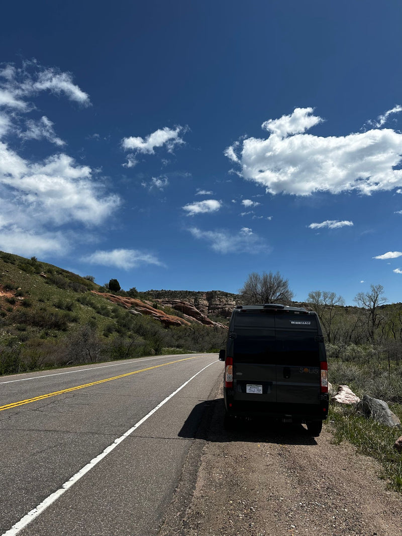  cloudy sky.|RV rental camper van with pop-top at a spring campsite — photo 6