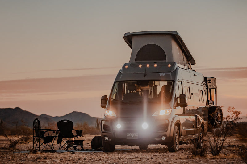 Dusk desert scene with an RV rental camper van and camping chairs. Perfect for your next adventure. — photo 8