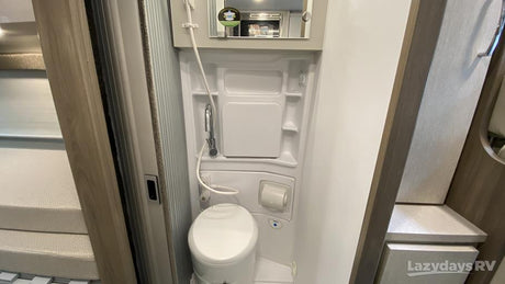 This RV rental features a compact wet bath with a toilet, shower, and sink, designed for efficient use of space.