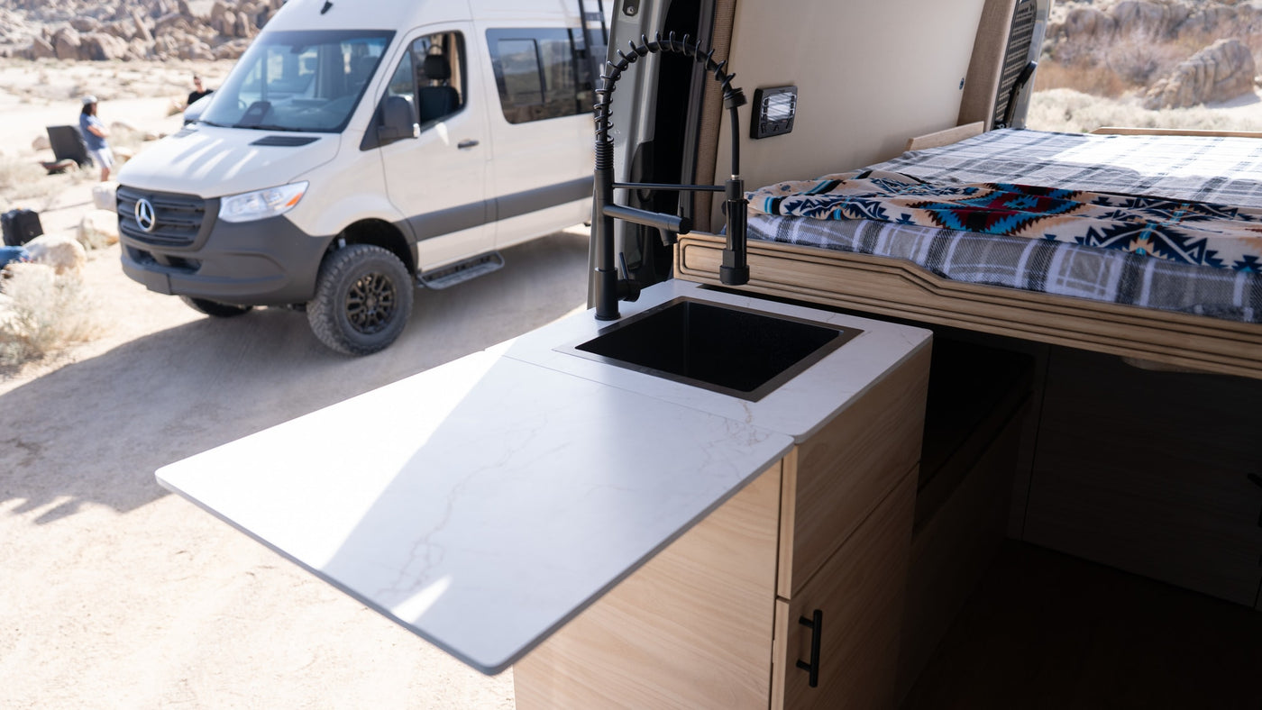  and a cozy bed area.|Modern rv rental kitchen: induction cooktop — photo 7