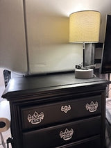 This compact RV rental bedroom offers practical comfort: a black dresser with lamp & speaker for your travel needs.