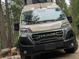  and a dazzling city view at dusk.|Inside a camper van RV rental: driver's view of the dashboard