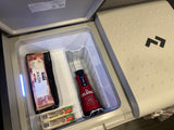 Inside an RV rental's Dometic cooler: Kirkland bacon, La Colombe cold brew, and Frigo string cheese for the road.
