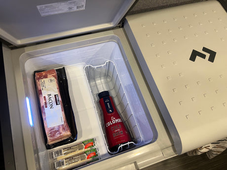 Inside an RV rental's Dometic cooler: Kirkland bacon, La Colombe cold brew, and Frigo string cheese for the road.