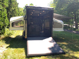 Explore nature with this unique RV rental: a converted cargo trailer featuring pop-out tents and an awning for versatile camping.