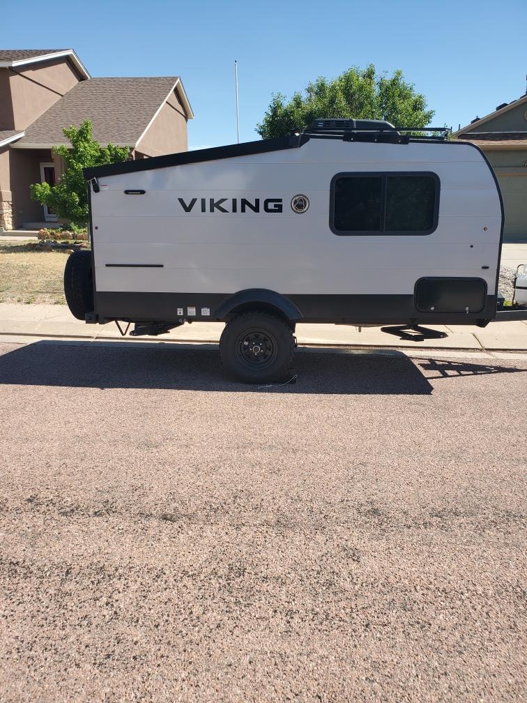  set up for a camping adventure.|Modern light gray Viking travel trailer for RV rental — photo 3