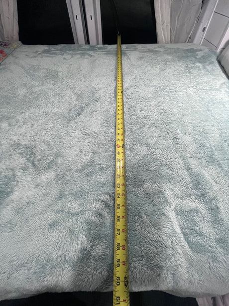 Measuring the cozy 60-inch bed blanket in an RV rental interior, ready for a comfortable night's sleep in a camper.
