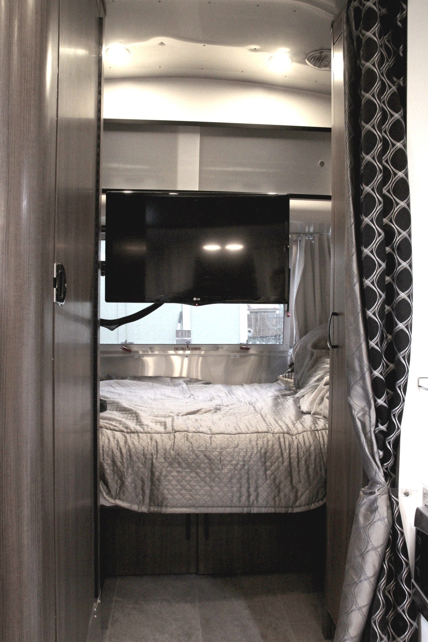  & overhead lights create a relaxing camper space.|Inside an RV rental: a compact dining nook with a table set for a meal — photo 19