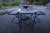 This portable camping kitchen with a Gas One stove is ideal for your RV rental adventure, with campers enjoying a fire.