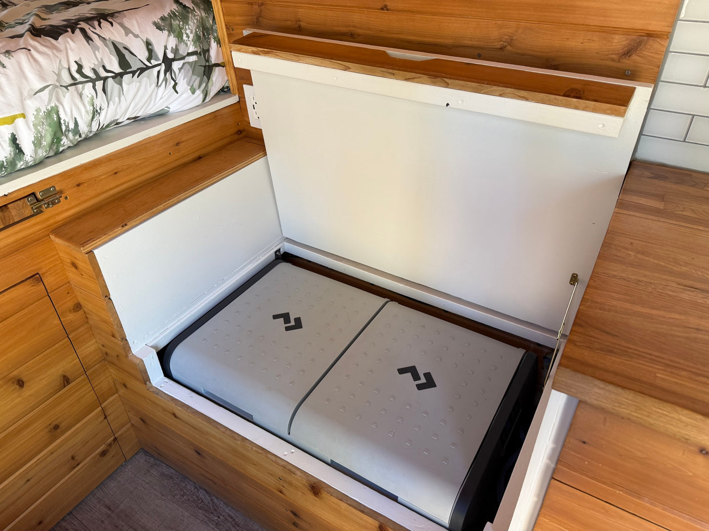 RV rental: Open storage compartment in a camper van showing a Dometic cooler, ideal for keeping items chilled. — photo 11