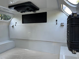 Spacious, white interior of an rv rental, featuring overhead AC, windows, & protective floor covering. Ideal for mobile travel.