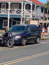 Lahaina, Maui street scene: a minivan and motorcycle parked near the Old Lahaina Courthouse. Perfect for your island adventure or even an RV rental trip!