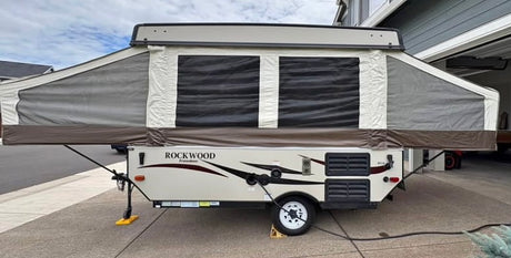 Rockwood Freedom pop-up camper, fully extended & ready for an RV rental trip. Provides cozy tent trailer lodging.