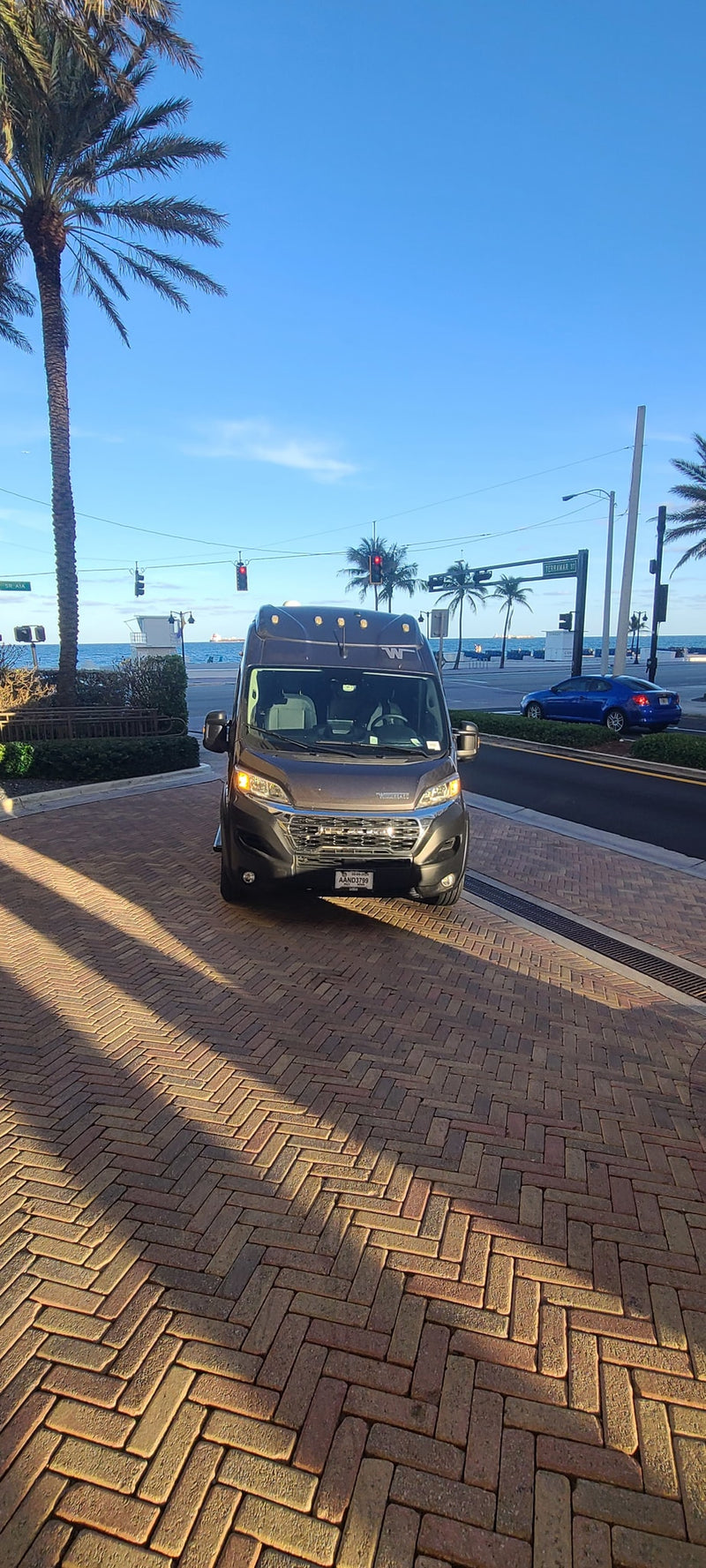  and a scenic beach road.|Dark grey Solis RV rental parked by ocean — photo 8
