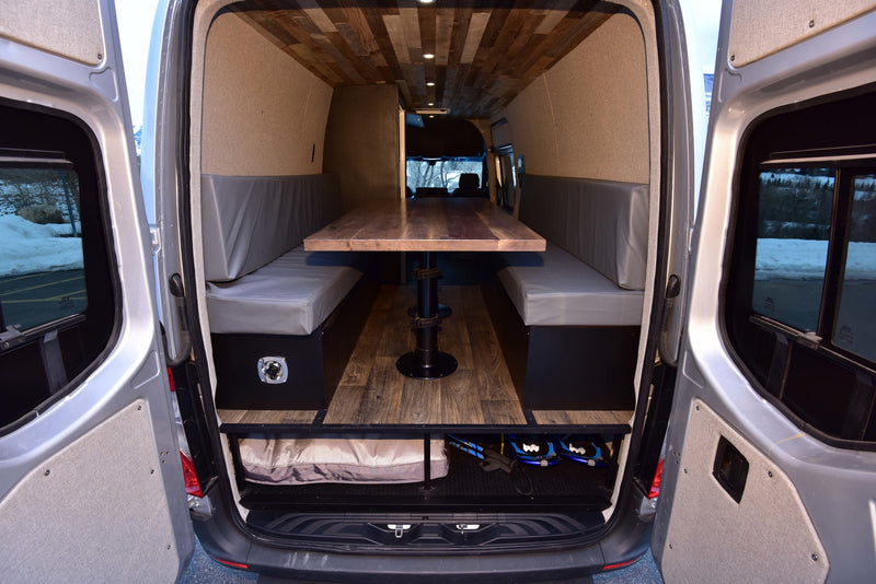  & scenic snowy mountain views.|Spacious camper van interior for RV rental. Features a dining area — photo 7