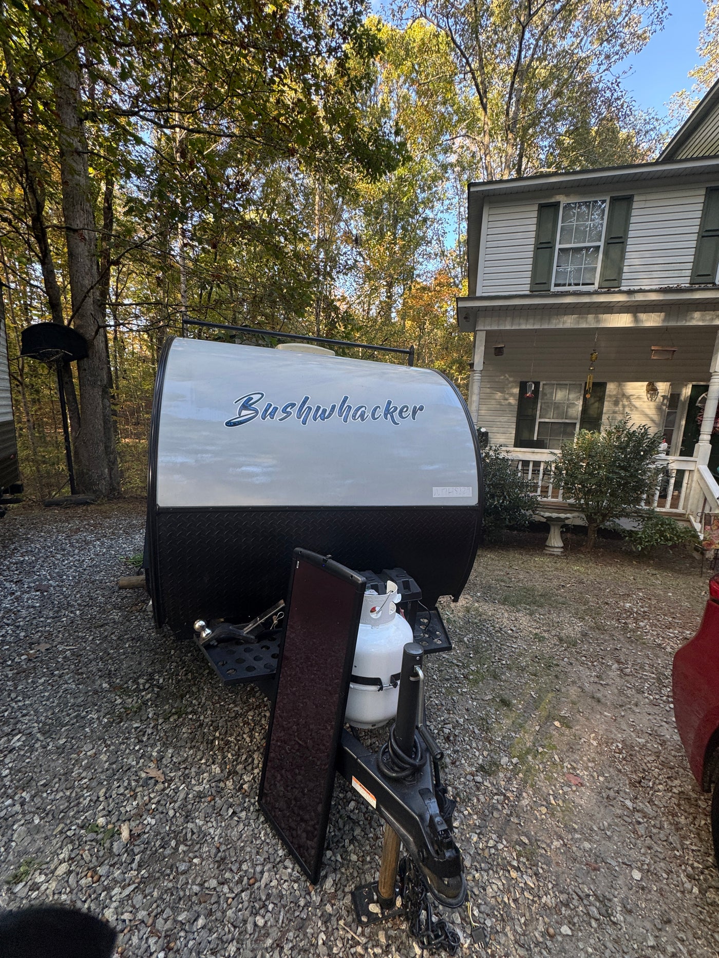 Teardrop style "Bushwhacker" RV rental trailer parked on a gravel driveway, ready for your next outdoor adventure. — photo 11