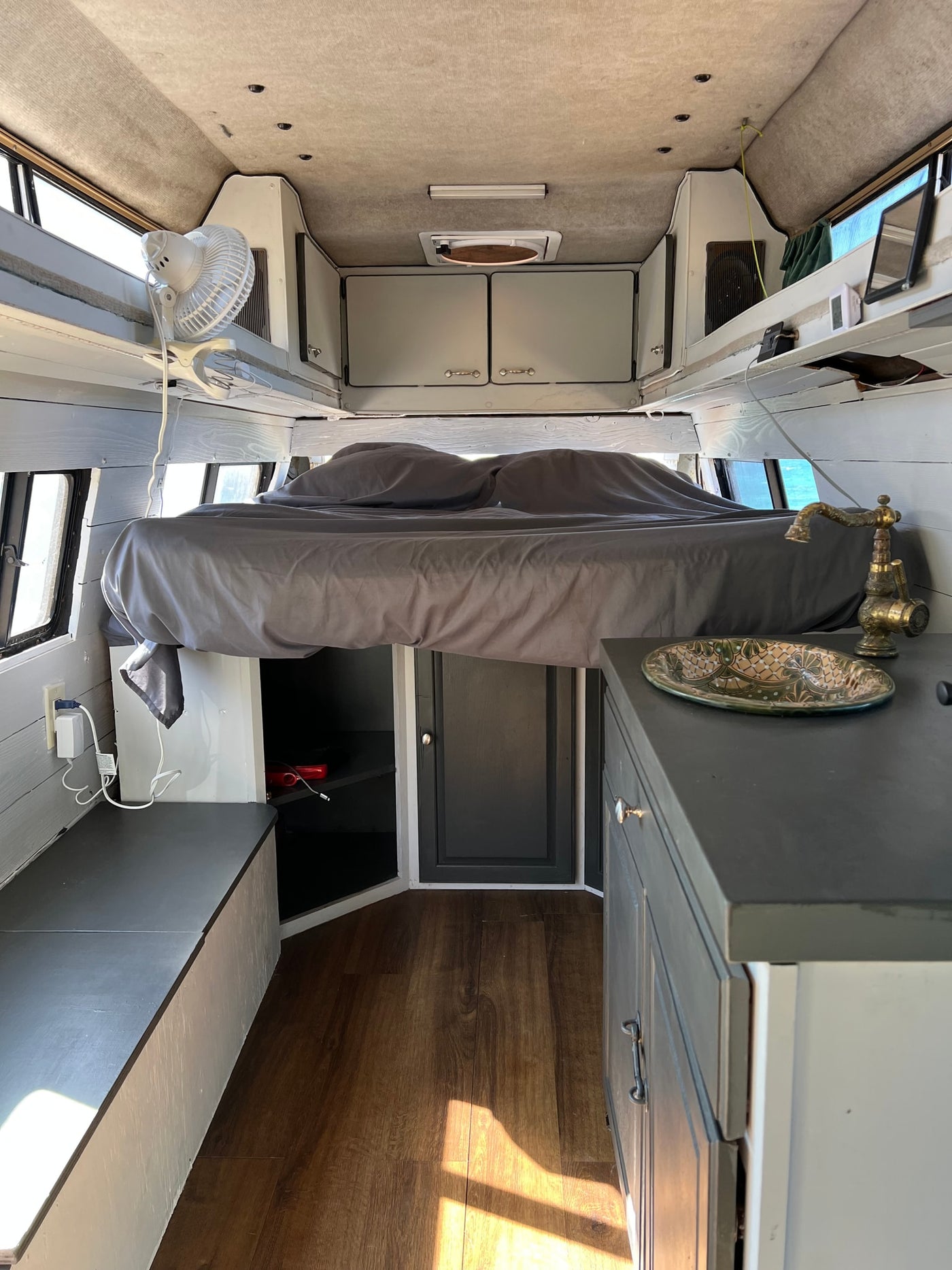  and a clip-on fan for comfort.|RV rental's cozy bedroom with a large bed — photo 15
