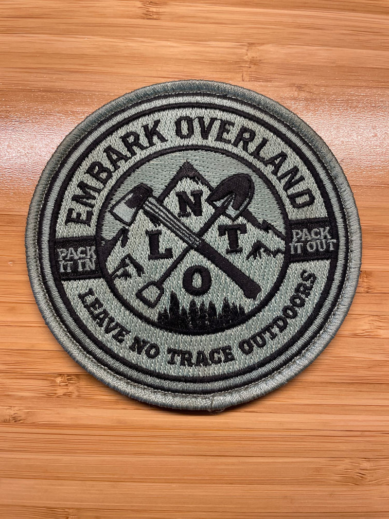 Embroidered 'Embark Overland' patch on wood. Features 'LNT' & 'Pack It In/Out'. Great for RV rental adventures! — photo 3