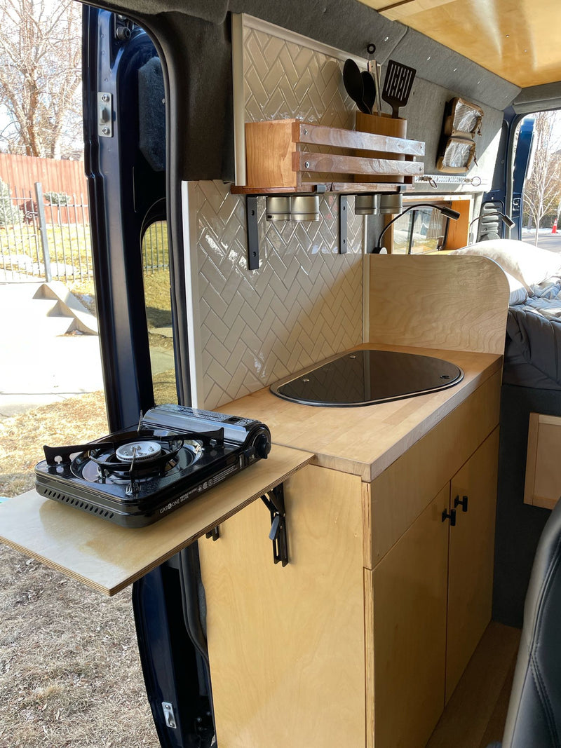  and power distribution.|Experience mobile living! This rv rental camper van features a dining setup with seats & table — photo 11