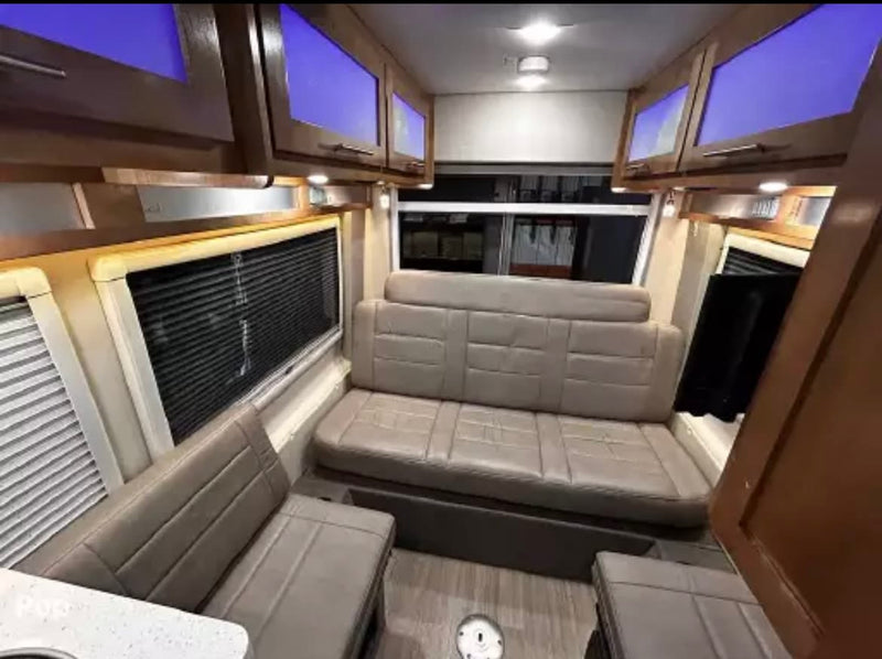  ideal for travel.|RV rental interior with cozy light-colored dinette seating — photo 17